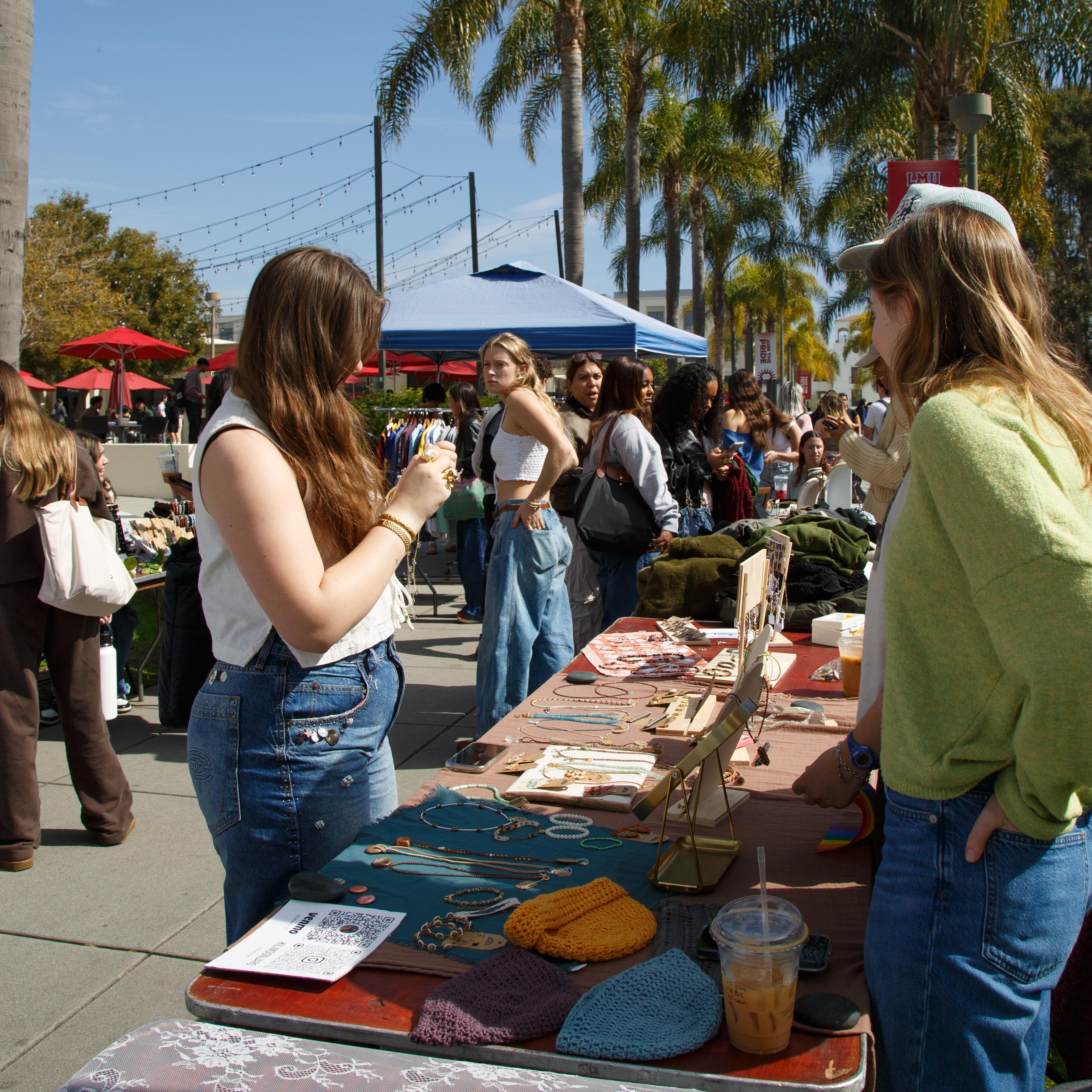 A group of students talk over a table at Wellness Wednesday.